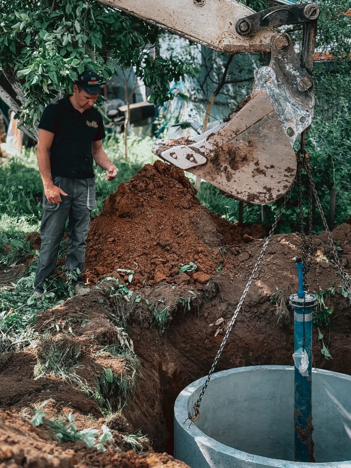 ClearFlow Septic technician setting a concrete septic tank during a residential backyard installation